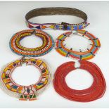Four African tribal Samburu single layer beaded necklaces and a beaded belt, largest diameter 22cm