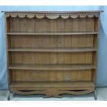 An oak bookcase with shaped apron and base, W144 x D26 x H137cm