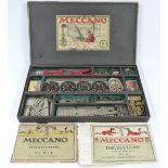 Meccano Outfit 5 with unpainted parts and black wheels, in original box with instructions.