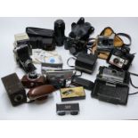 A collection of cameras and accessories including several Polaroid, Minolta 7000 with 50mm lens,