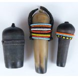 Three carved African tribal Sambu carved horn snuff bottles, two with beaded decoration, vendor