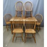 A bespoke oak extending table and six chairs in the Arts & Crafts style, made by US Amish craftsmen,