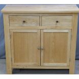 Modern light oak or similar sideboard two drawers above cupboards and cupboards and drawers to the