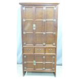 Chinese or Korean elm cabinet or wardrobe with hinged doors to top, three drawers to middle and