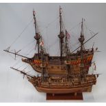 Two wooden models of galleons, both on stands, largest L88 x H70cm