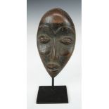African tribal carved passport / miniature mask on bespoke stand, Liberia, probably early 20thC,