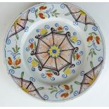 An 18thC London Delft plate with a geometric polychrome decoration, diameter 22cm