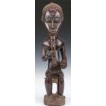 African tribal Baule carved figure with braided beard seated on a stool, H51cm. Provenance:- part of