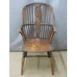 A 19thC elm seated Windsor armchair with hoop back