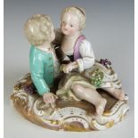 Meissen figure of sweethearts embracing, with applied grape and vine decoration, blue crossed swords