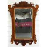 A mahogany wheatear mirror with bevelled glass and crossbanded rosewood and gilt decoration,