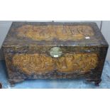 Chinese heavily carved camphor wood trunk with engraved brass lock raised on carved bracket feet,