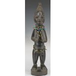 African tribal Yoruba carved fertility figure with 19thC Venetian chevron bead necklace, H31cm
