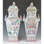 A pair of 19thC Chinese famille rose covered vases with twin figures to each handle and female