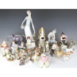 A large collection of ceramic figures including Staffordshire, Lladro, Goebel Hummels, Beswick,