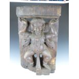 An 18th/19thC carved wood Indian figural temple piece depicting a Hindu deity/god, W71 x D16 x