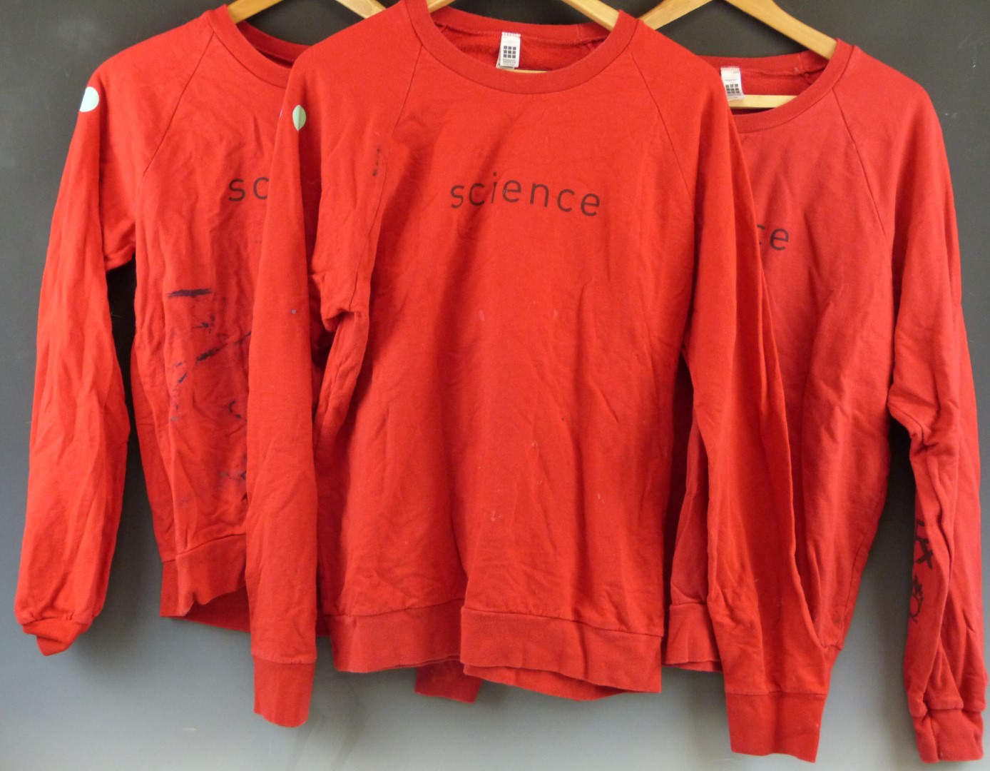 Three red Damien Hirst/ Science sweatshirts with Hirst spot design to sleeves and logos front and