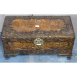 Chinese heavily carved camphor wood trunk with engraved brass lock raised on carved bracket feet,