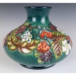 Moorcroft squat pedestal vase with tube lined flower decoration, H11cm