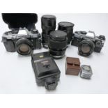 Two Olympus OM10 SLR cameras with f=50mm 1:1.4, f=50mm 1:1.8, and 35-70mm 1:4 lenses together with