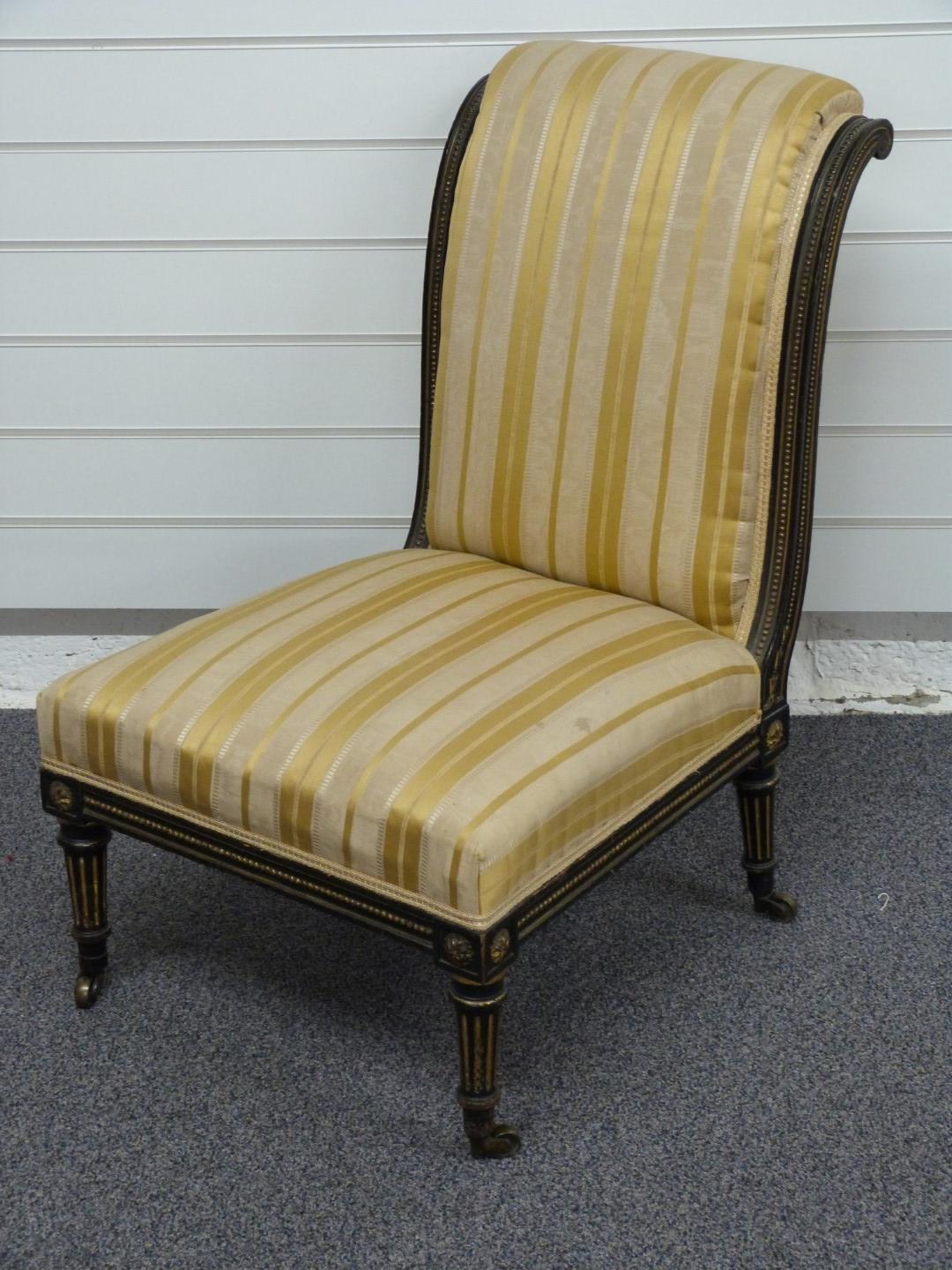 A 19thC upholstered nursing chair with ebonised and gilt decoration