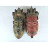 A pair of African Ivory Coast tribal Baule carved male and female masks purchased by the vendor in