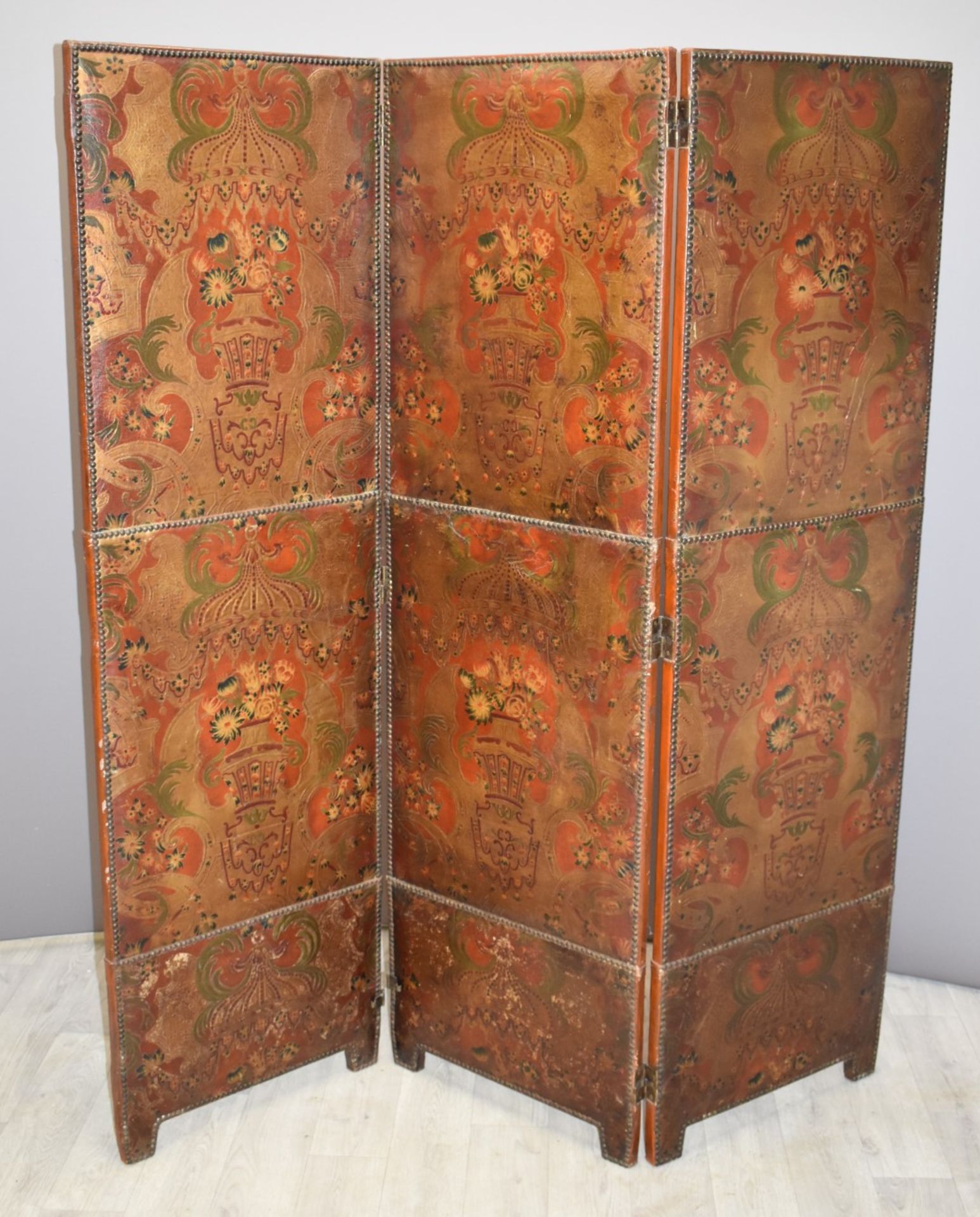 An oriental embossed three fold screen with studwork decoration, probably early 20thC, W145 x