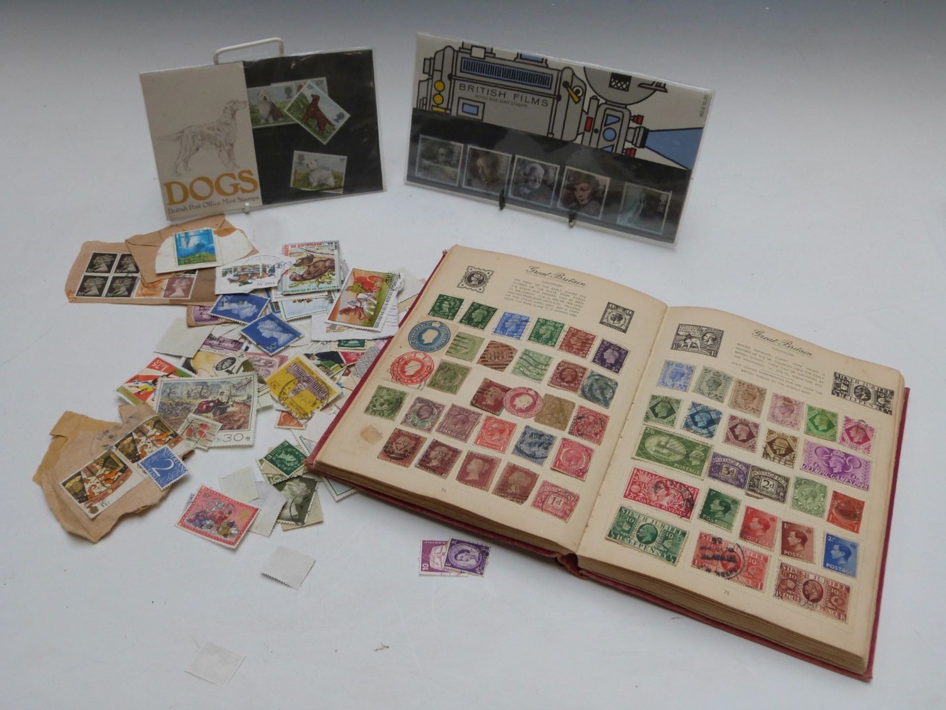 Nelson stamp album and tin of stamps