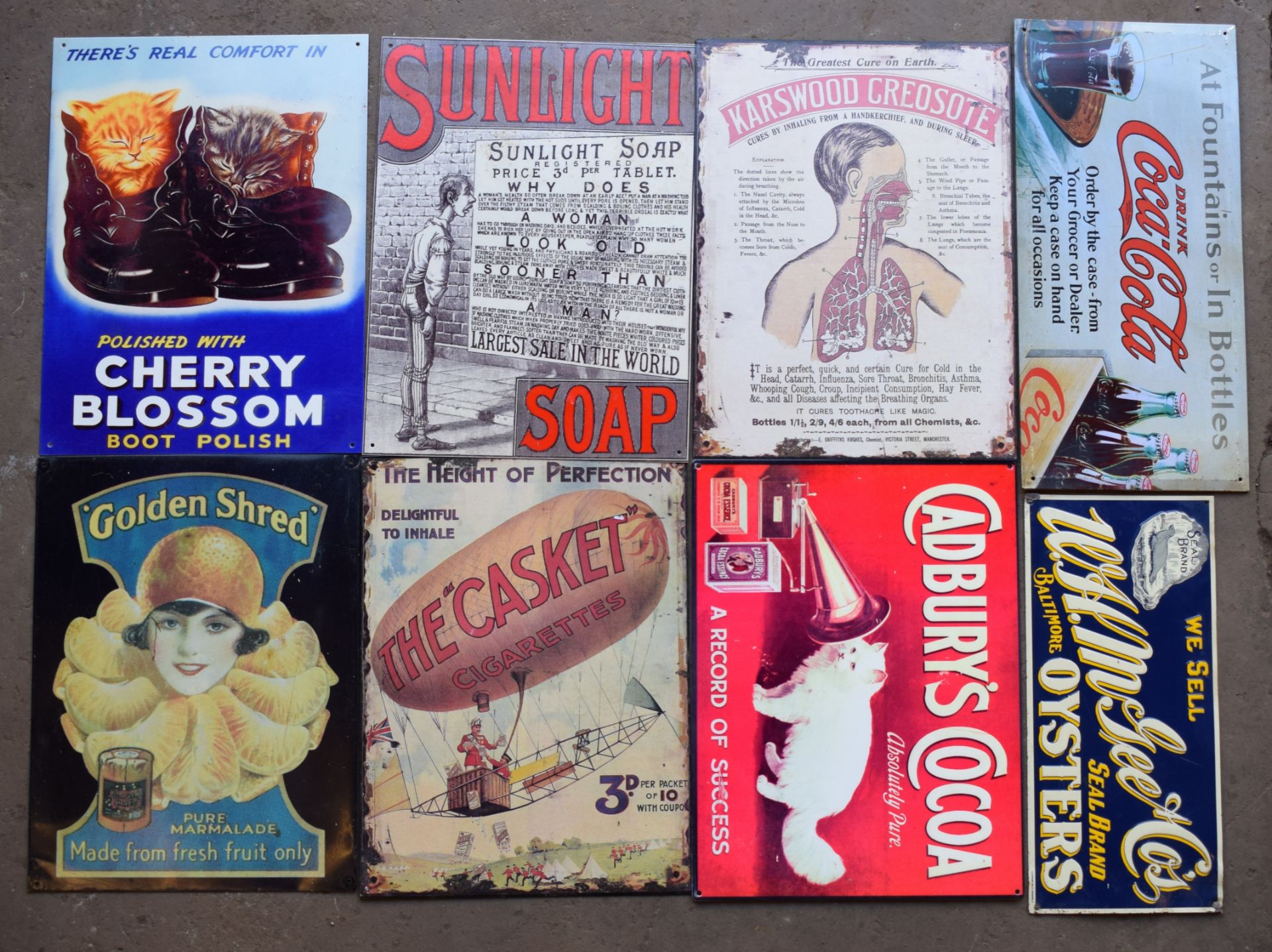 Eight metal advertising signs to include Golden Shred, Cadbury's Cocoa, W H McGee oysters etc,