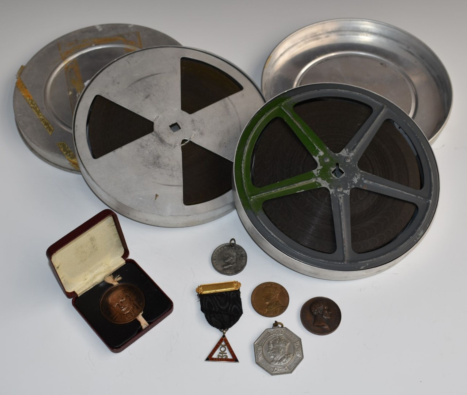 Mickey Mouse Cats Away 16mm cine film, The Sawdust Ring 16mm cine film and various medallions and