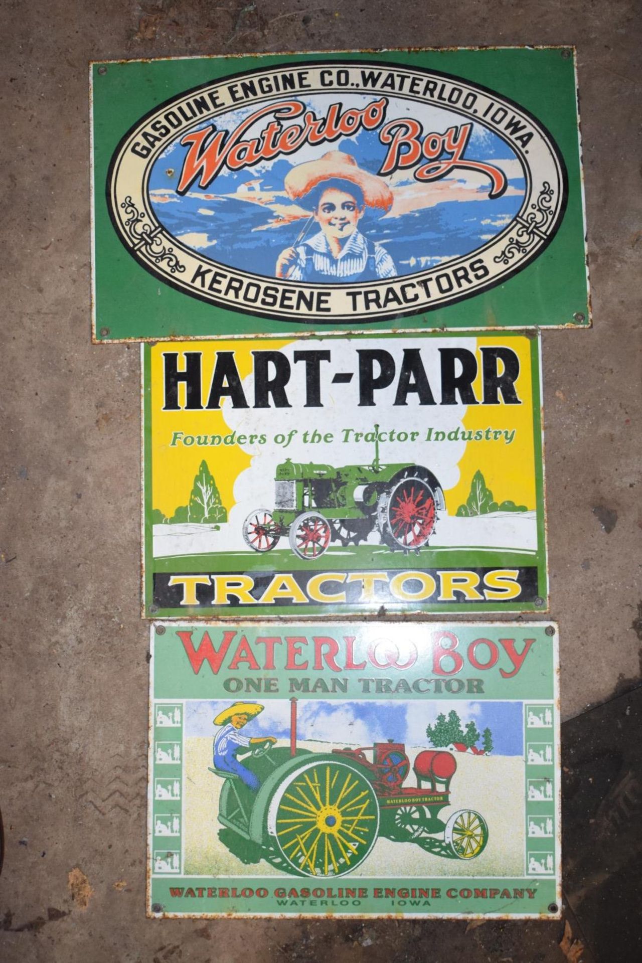 Three enamel advertising signs comprising Hart-Parr and two Waterloo Boy, largest 26 x 44.5cm PLEASE