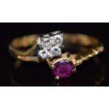 An 18ct gold ring set with an oval cut ruby and four diamonds, 2.9g, size N