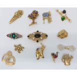 A collection of designer brooches including Monet, Piadoro, etc