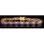 A 9ct gold bracelet set with oval cut rubies and diamonds, 13.7g