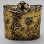 German silver gilt trinket or pill box with embossed decoration of cherubs in a landscape, with