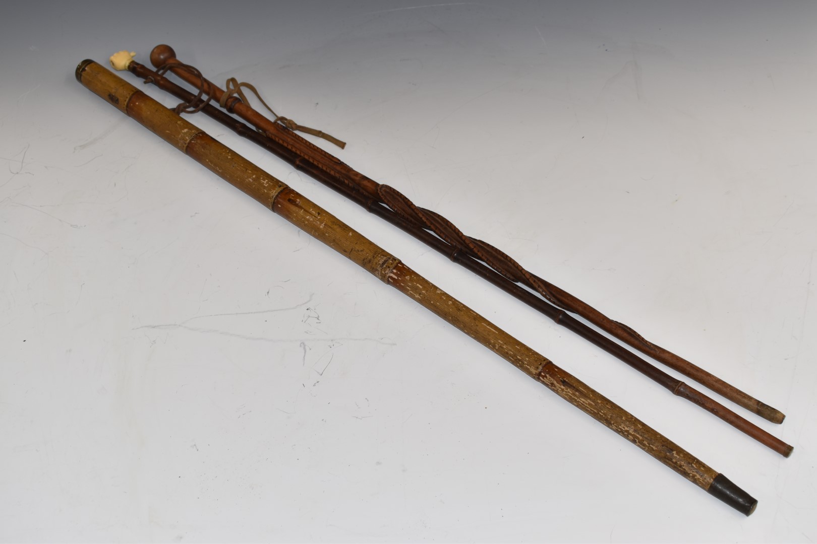 Three walking sticks comprising 19th or early 20thC example with concealed telescope impressed '