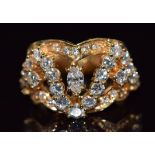 An 18ct gold ring set with a marquise cut diamond and round cut diamonds, size M, 10g