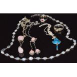 Two silver necklaces set with rose quartz, a silver pendant set with green and blue enamel, a