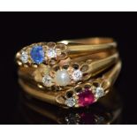 An 18ct gold ring made up of three rings, one  set with a pearl and diamonds, the other a sapphire