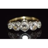 An 18ct gold ring set with five old cut diamonds measuring approximately 0.5, 0.35, 0.35, 0.14 & 0.
