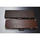 Two vintage gun cases, both with leather style finish and fitted interiors, largest 82x24x8cm.