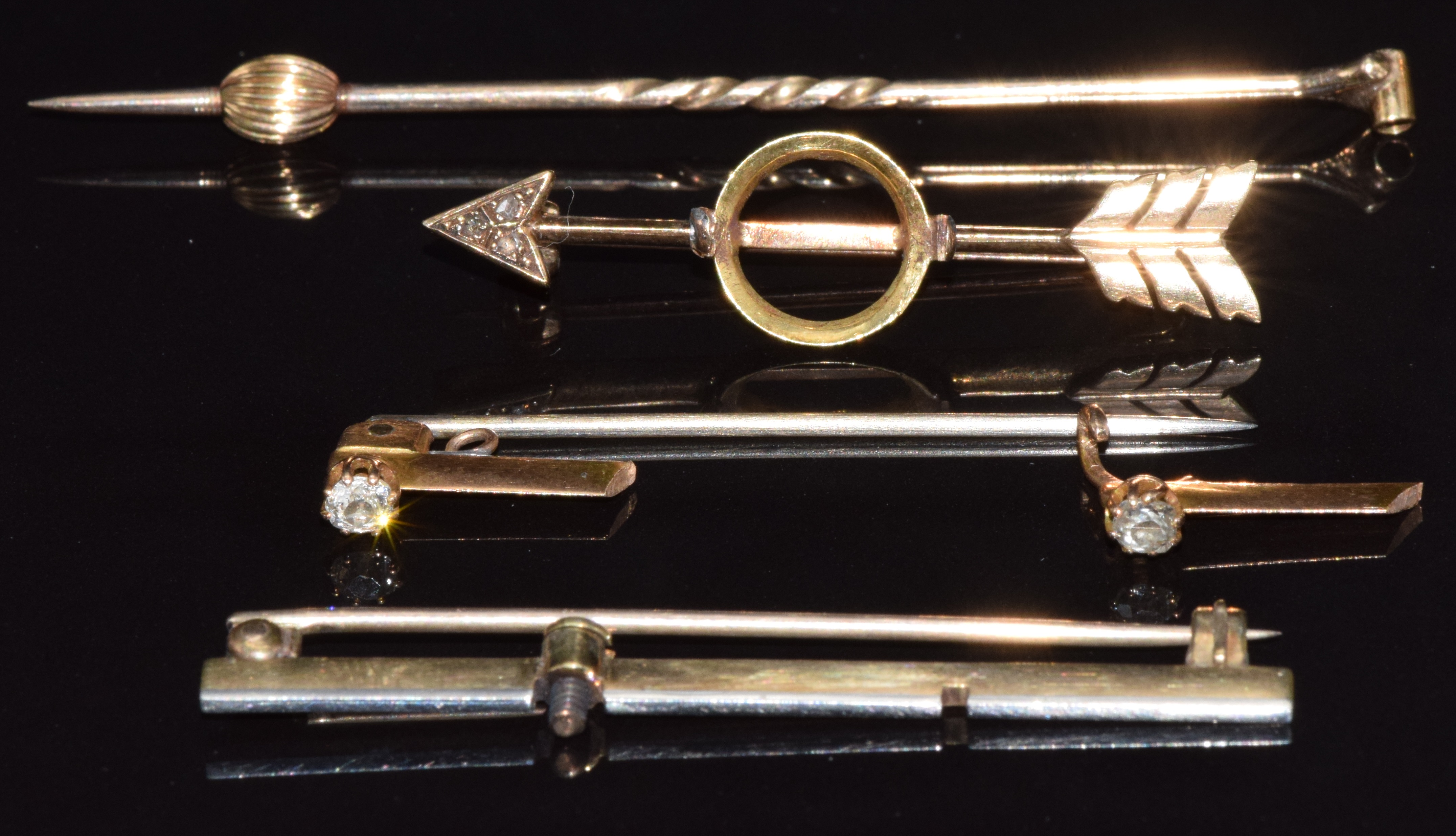 Four sections of gold brooches/ stick pins, 8.9g