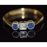 An 18ct gold ring set with a diamond and sapphires, 2.2g, size K