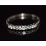 An 18ct gold half eternity ring set with nine diamonds, 1.3g, size P