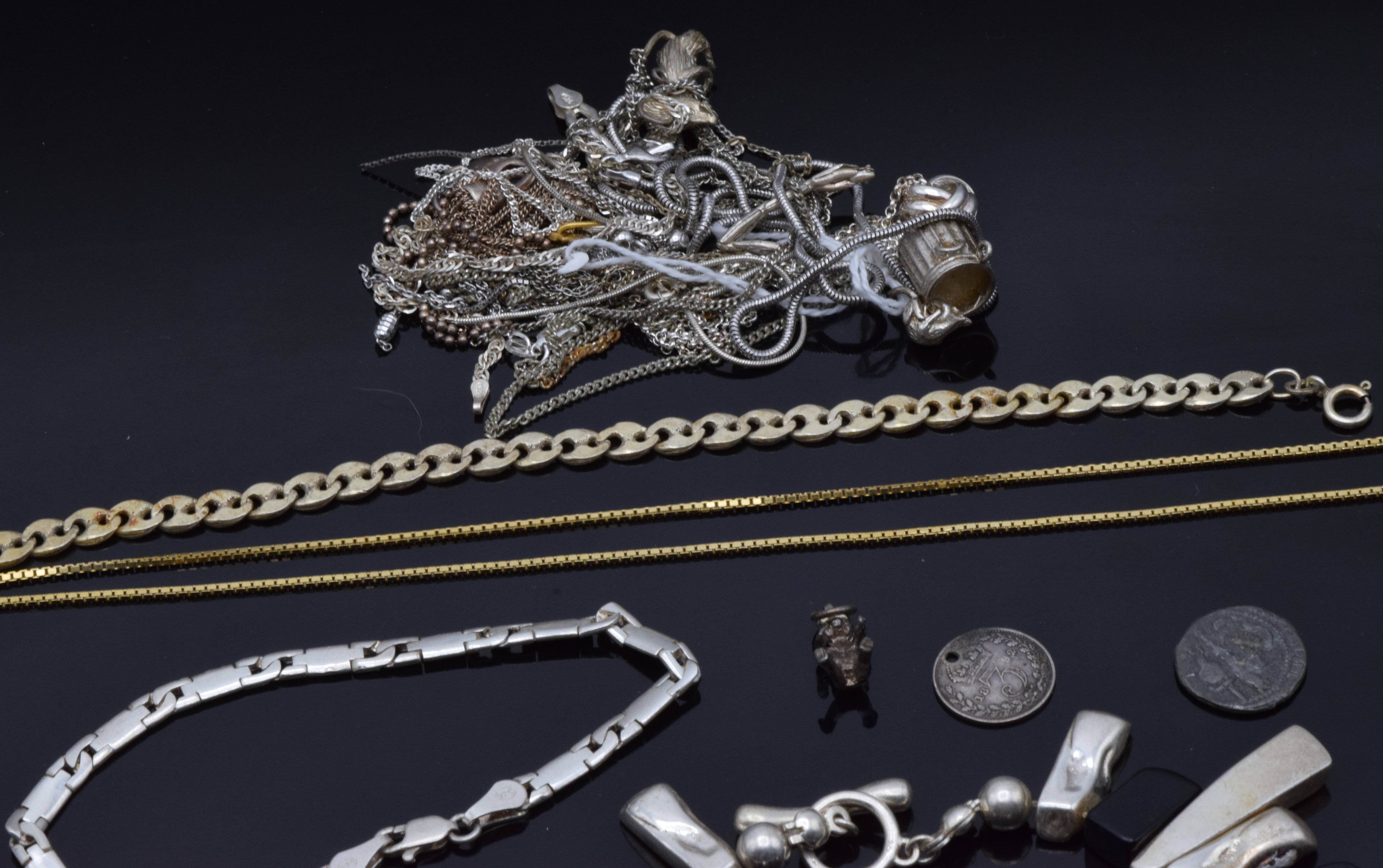 A collection of silver jewellery including four bracelets, matching bracelet and necklace, chains,