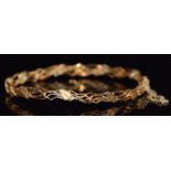A 9ct gold bangle with ivy decoration, 9.3g
