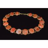 An 18ct gold necklace made up of oval carnelian agate cabochons, 26cm long