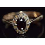 A 9ct gold ring set with a garnet and paste, 3.8g, size U