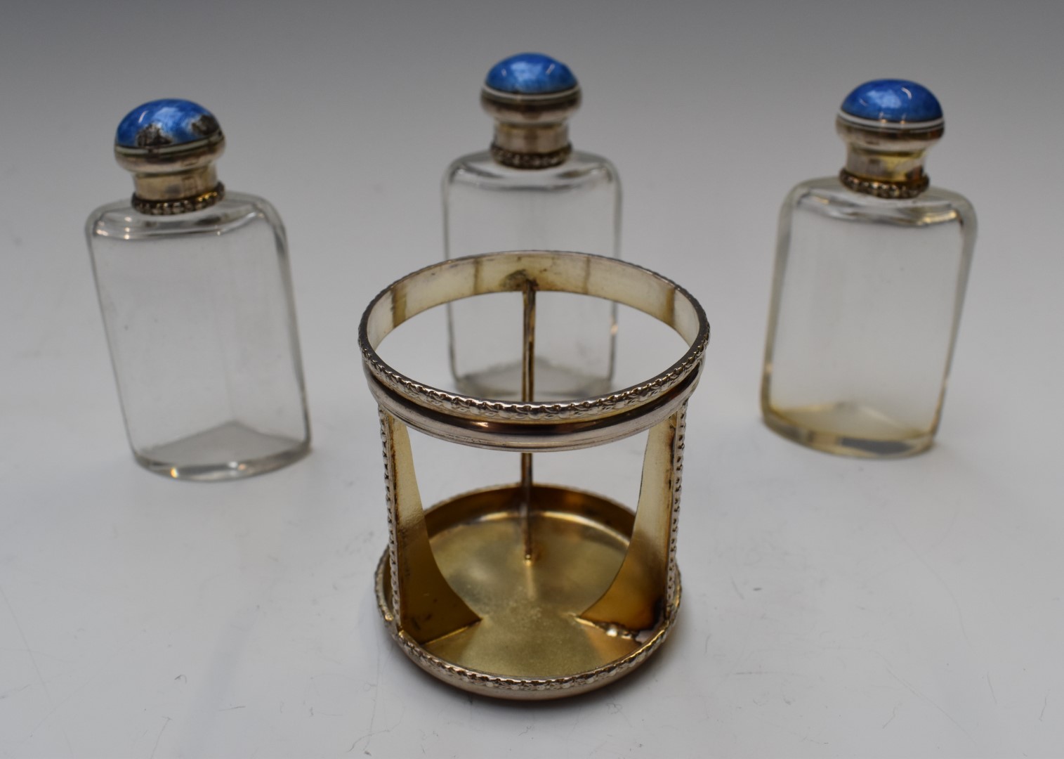 George V hallmarked silver and guilloché enamel three bottle scent bottle set, Birmingham 1912, - Image 3 of 5