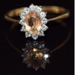An 18ct gold ring set with an oval cut yellow sapphire of approximately 0.75ct surrounded by